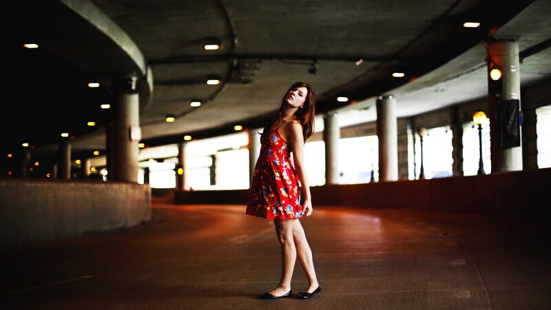 woman in red dress under overpass