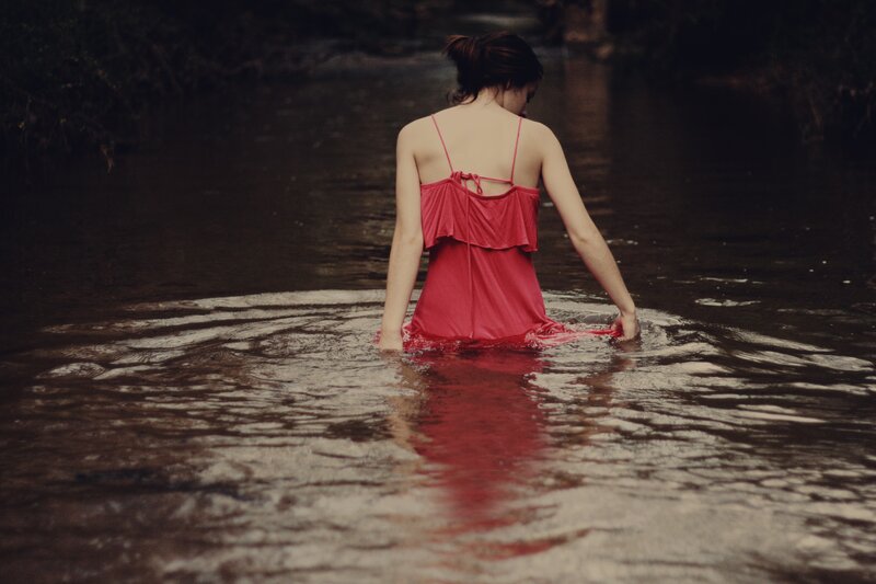 woman in red dress wading