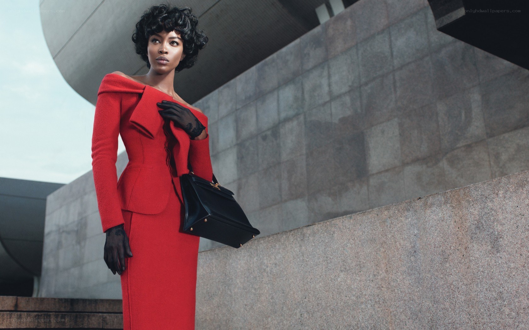 Woman in red dress with black bag