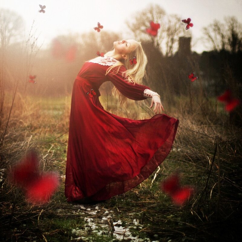 Woman in red dress with butterflies