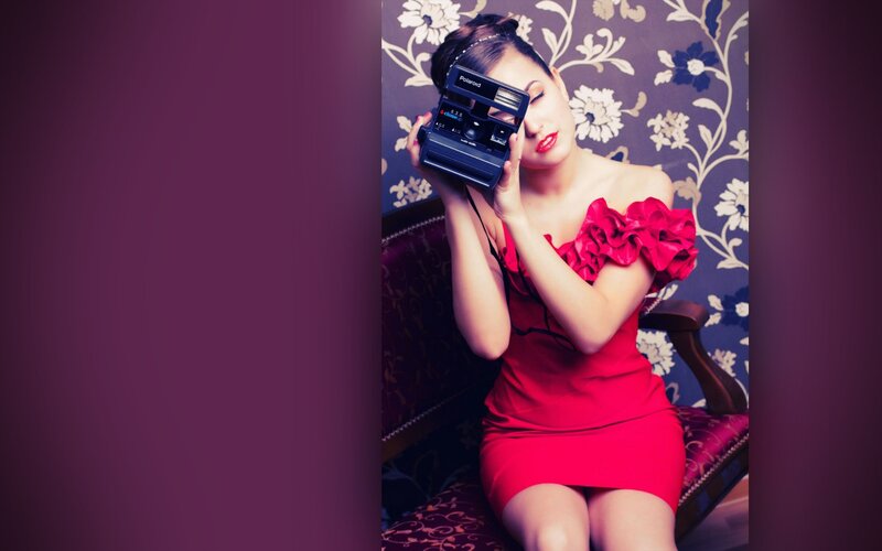 woman in red dress with camera