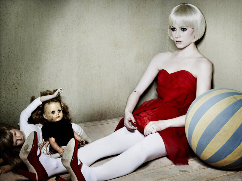 Woman in red dress with dolls