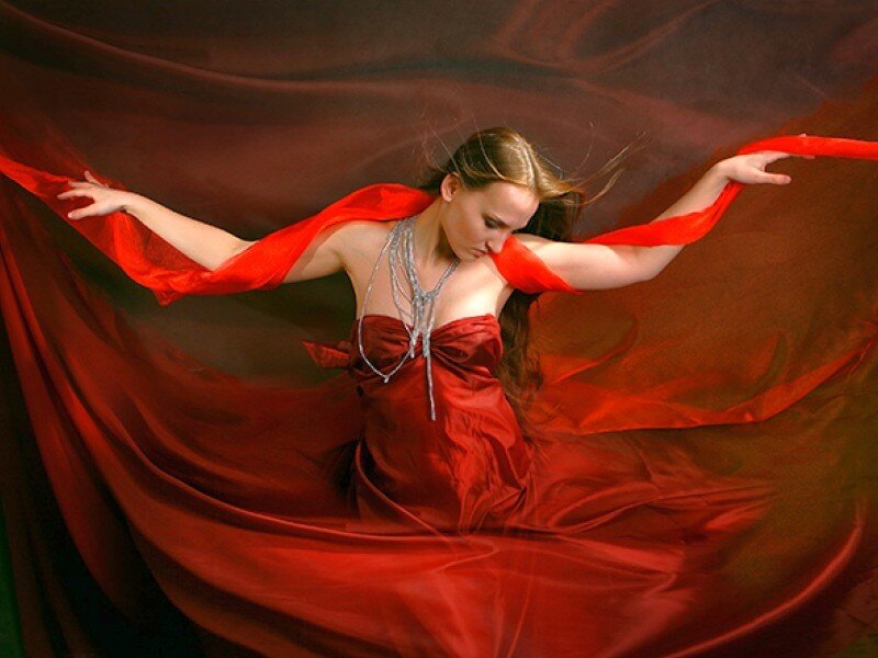 woman in red dress with flowing fabric