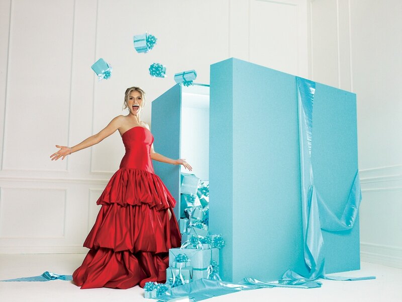 Woman in red dress with gift boxes
