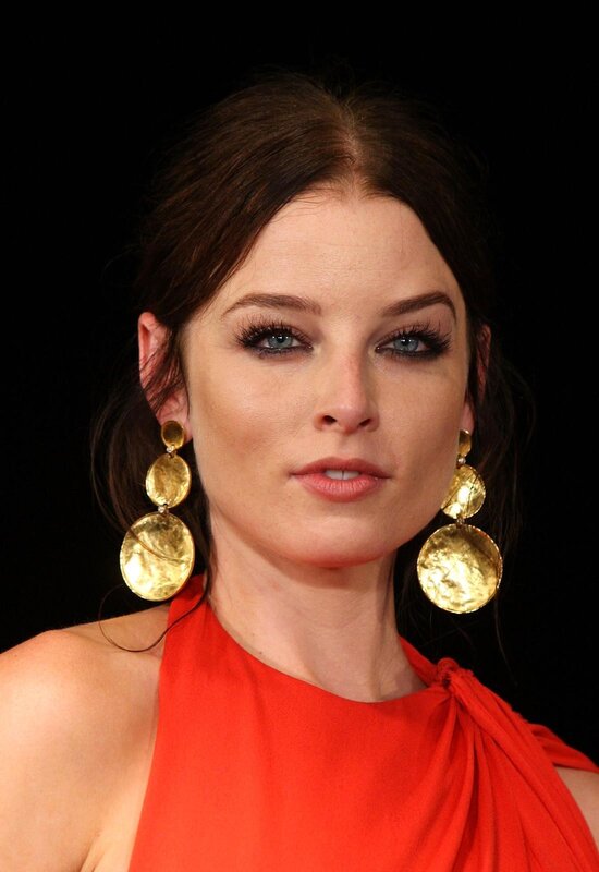 woman in red dress with gold earrings