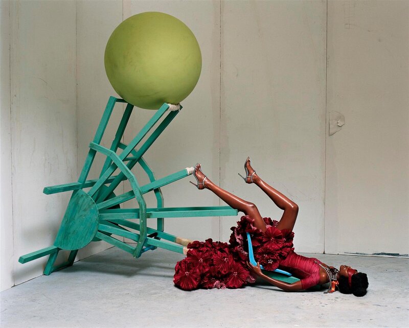 woman in red dress with green sphere