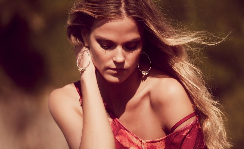 woman in red dress with hoop earrings