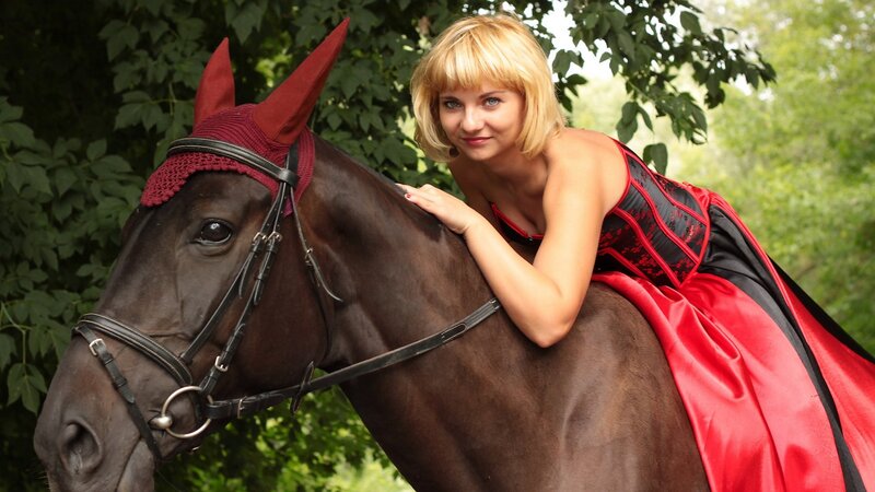 Woman in red dress with horse
