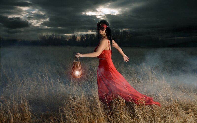 Woman in red dress with lantern