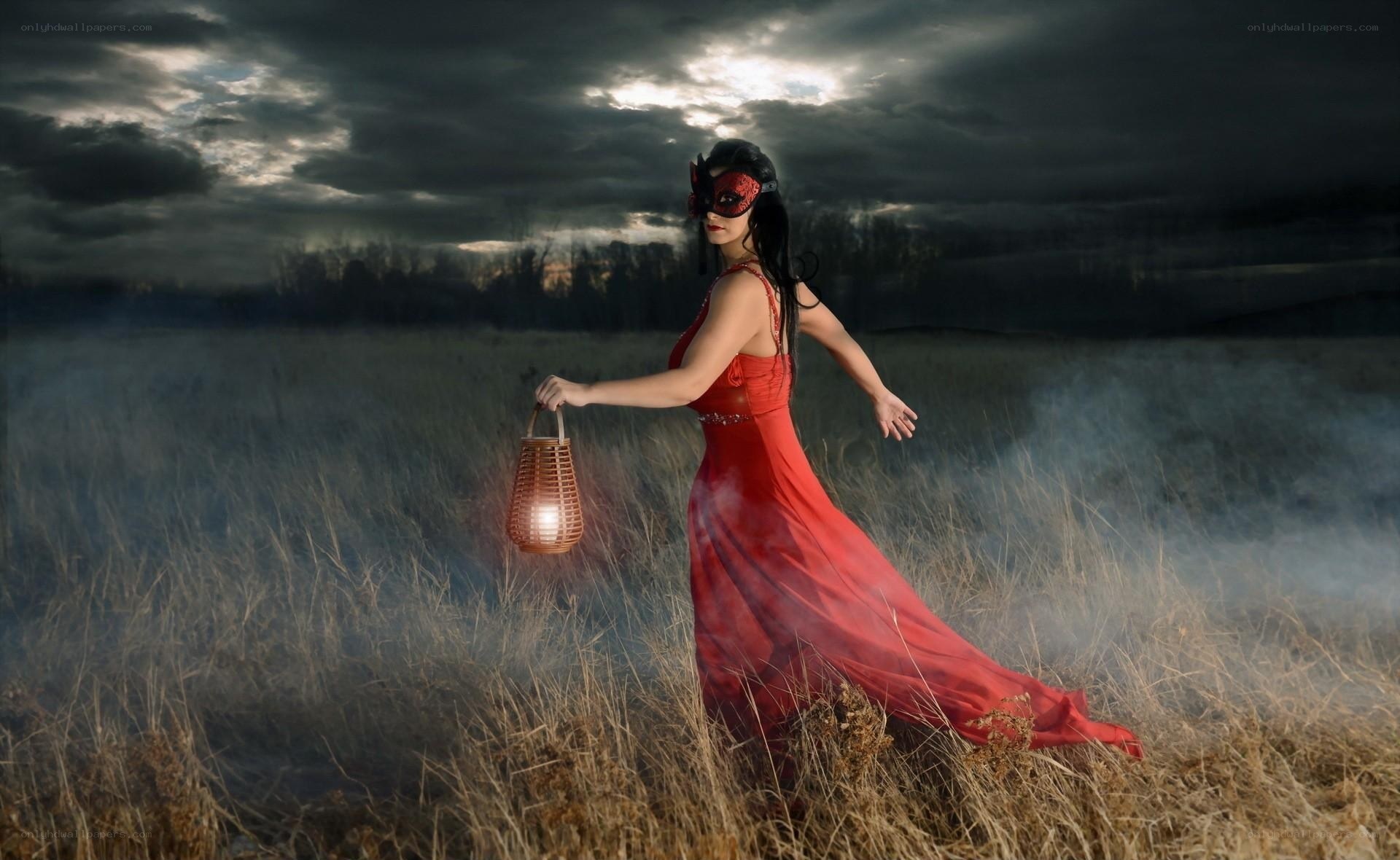 Woman in red dress with lantern