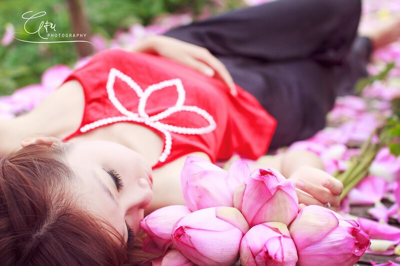 woman in red dress with lotus flowers