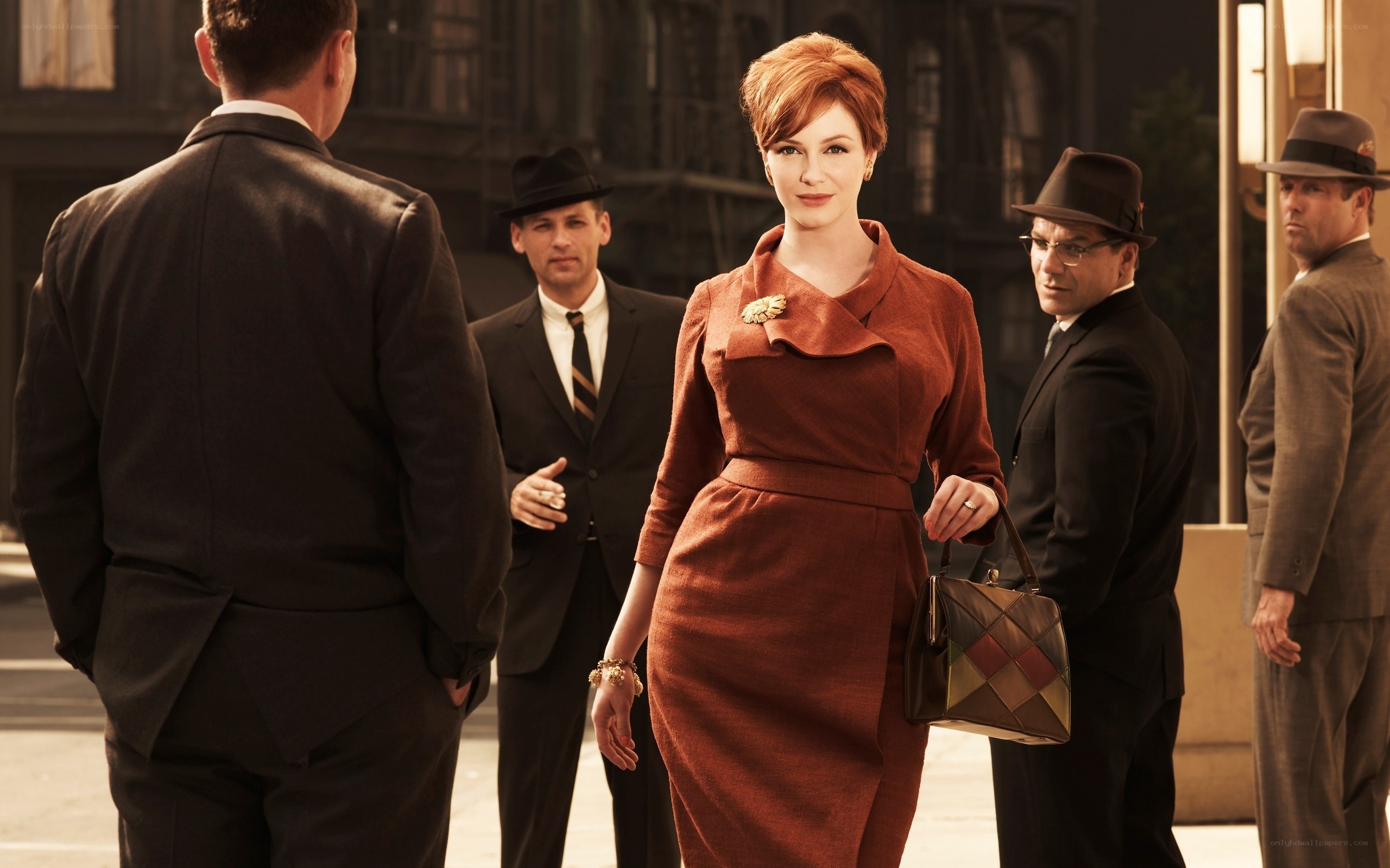 Woman in red dress with men