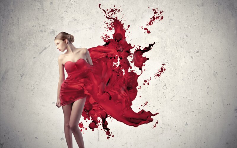 woman in red dress with paint splatter