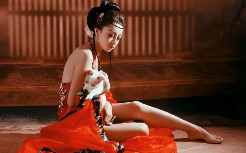 woman in red dress with puppy