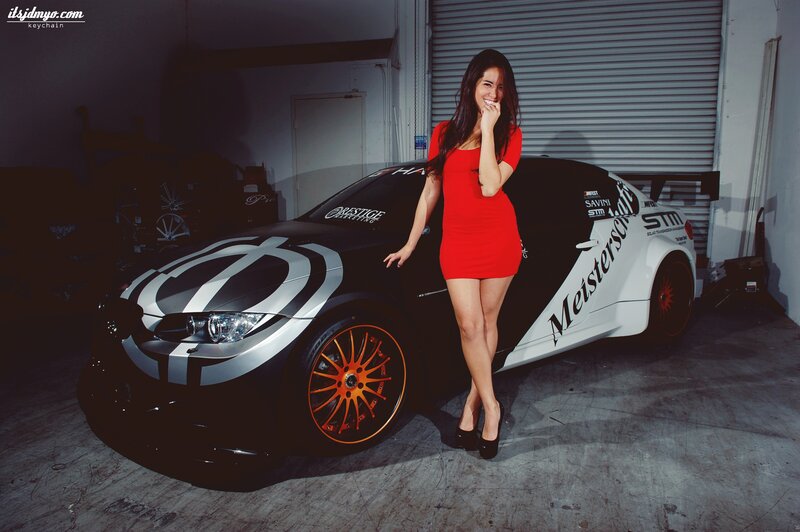 woman in red dress with race car