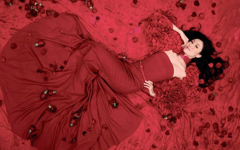 woman in red dress with rose petals