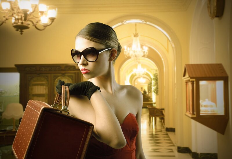 woman in red dress with suitcase