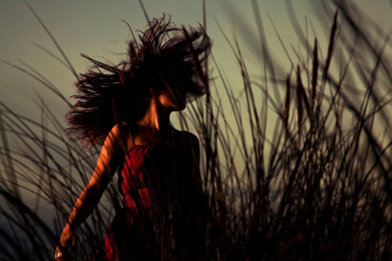 woman in red dress with wind-blown hair