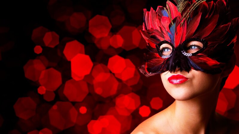 woman in red feather mask