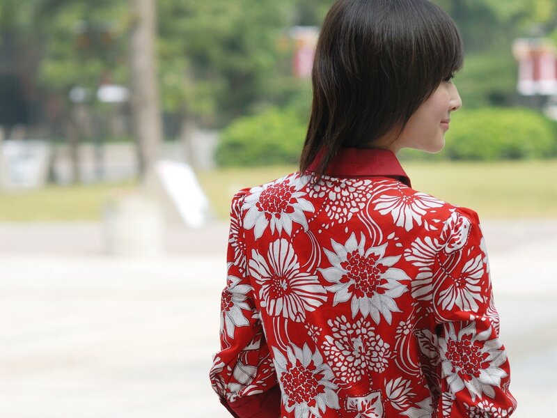 woman in red floral jacket