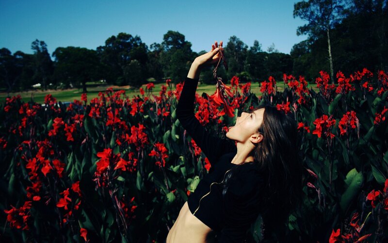 woman in red flower field