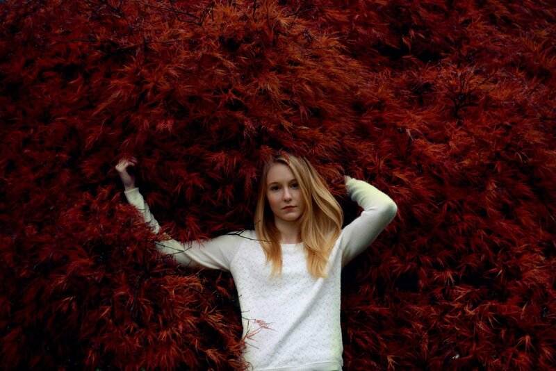 woman in red foliage