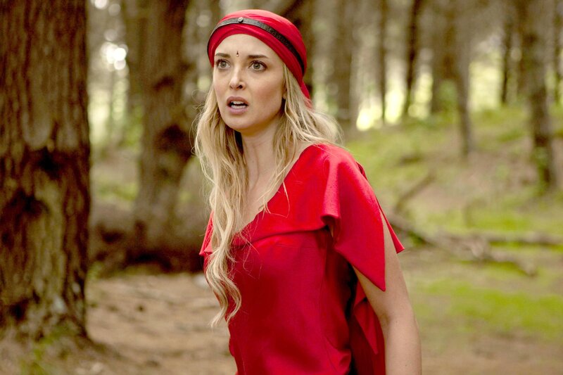 Woman in red forest scene