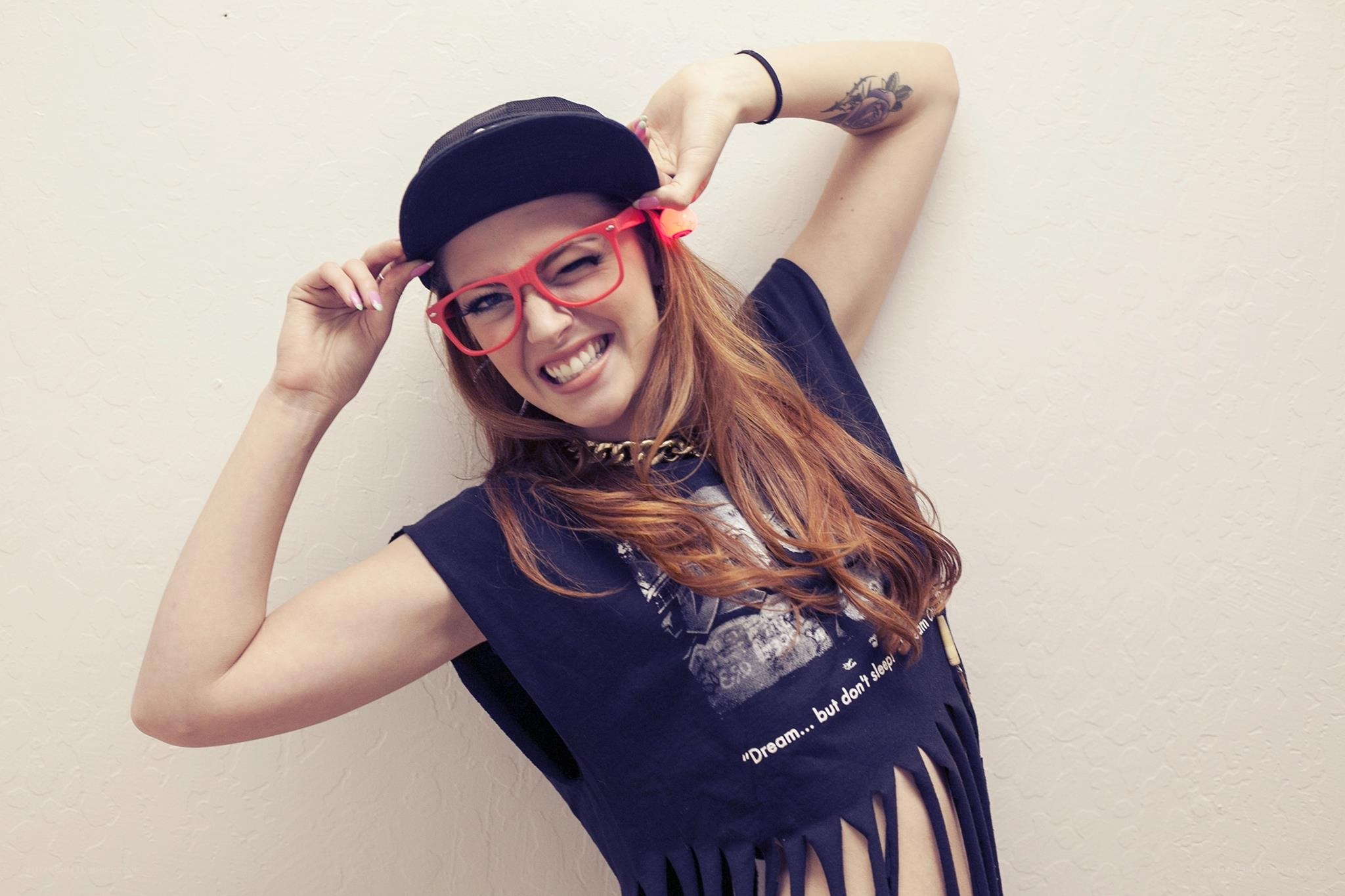 woman in red glasses smiling