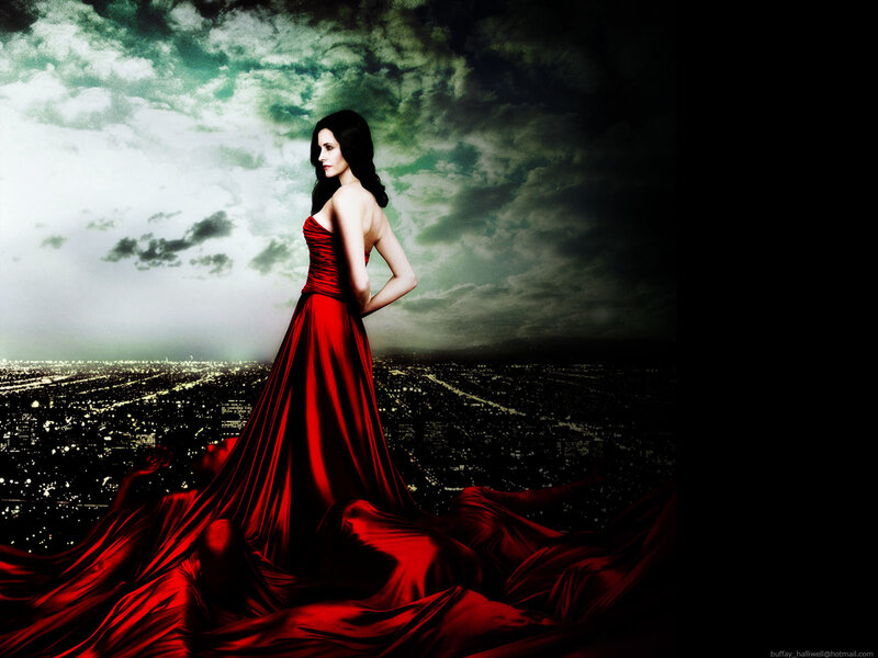 Woman in red gown on cityscape