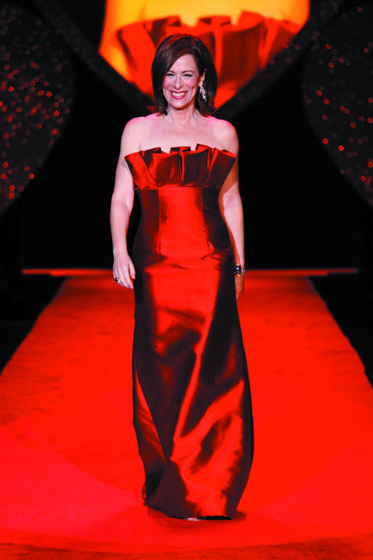 Woman in red gown on runway