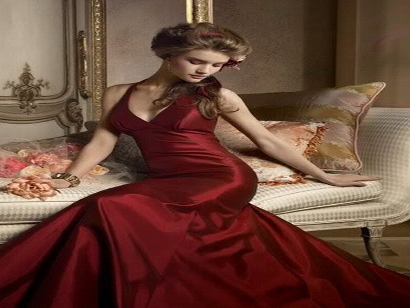 Woman in red gown on sofa