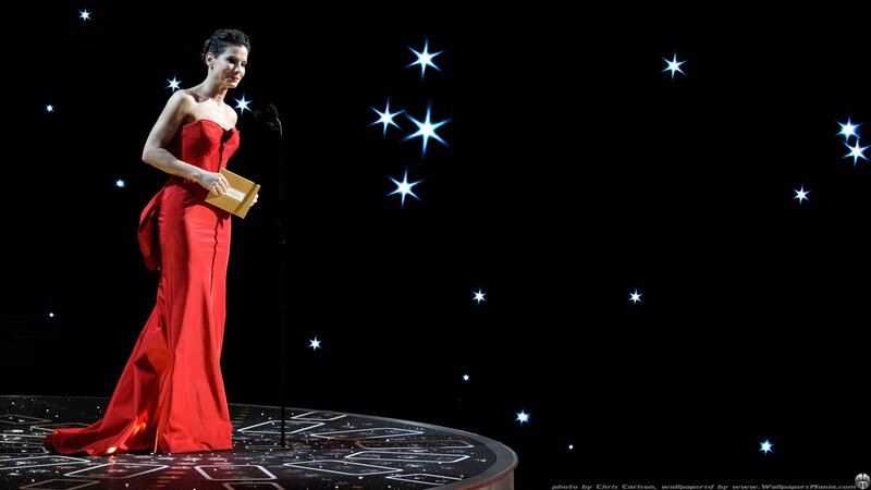woman in red gown on stage