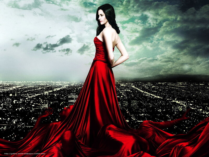 Woman in red gown overlooking city