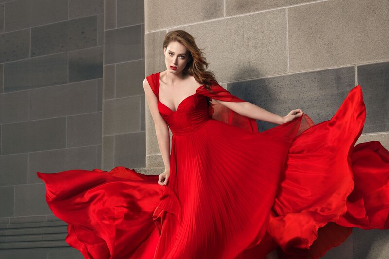 Woman in red gown posing