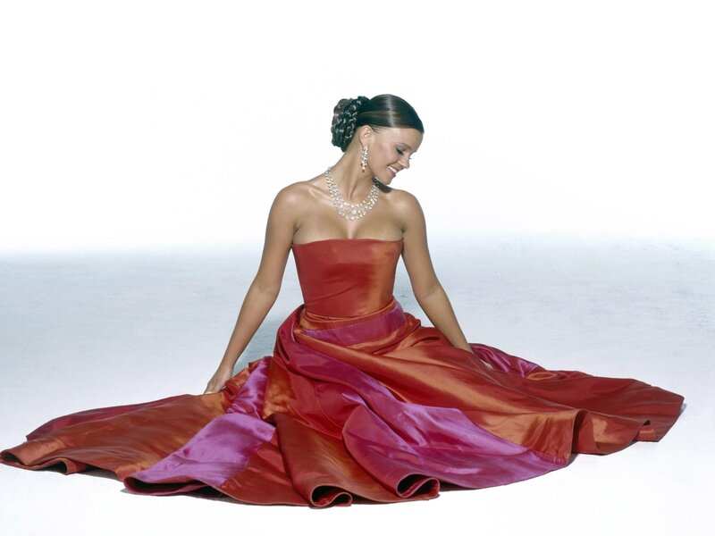 woman in red gown sitting