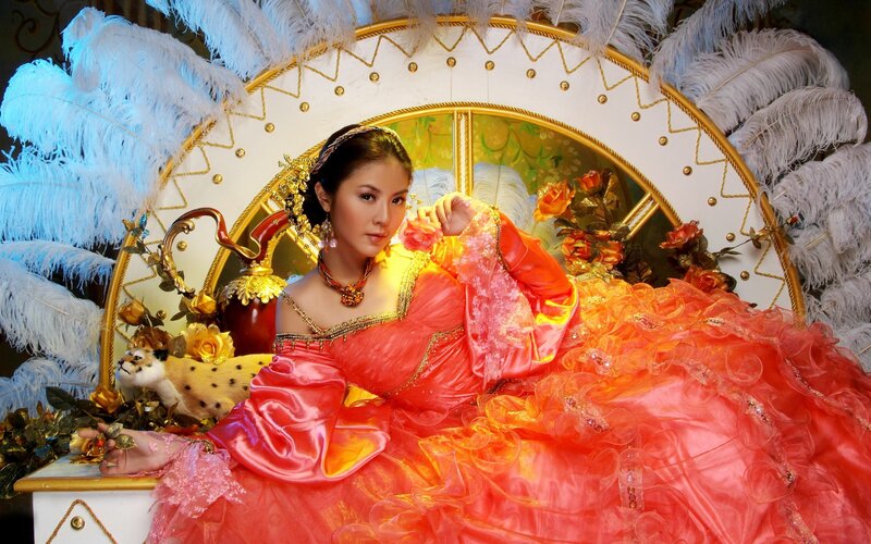 woman in red gown with feathers