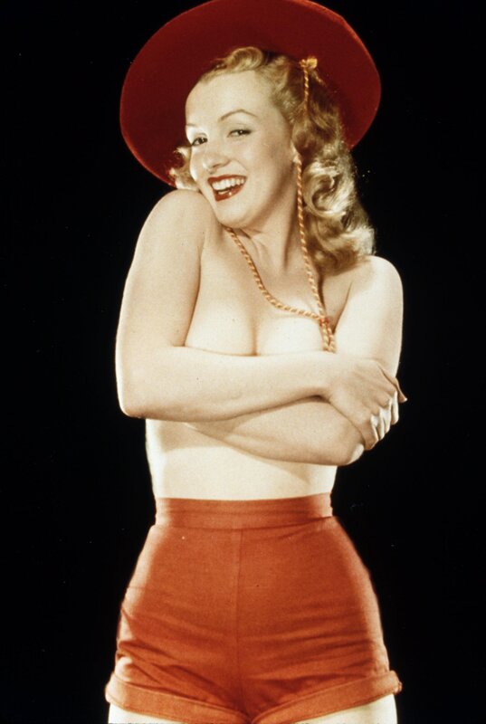 Woman in red hat and shorts