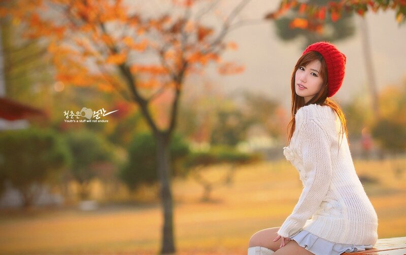 Woman in red hat autumn park