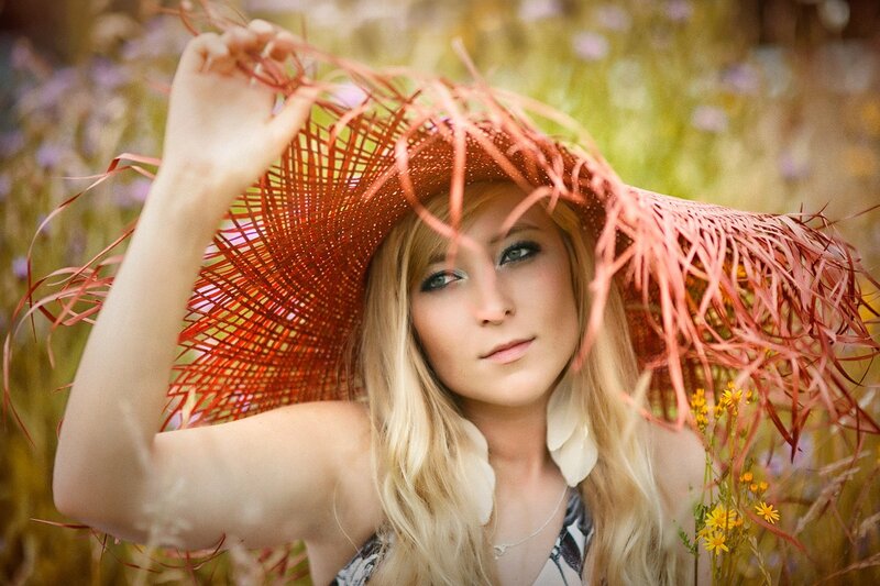 woman in red hat in field