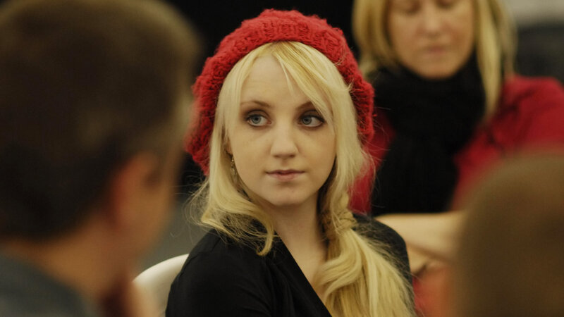 woman in red hat looking at camera