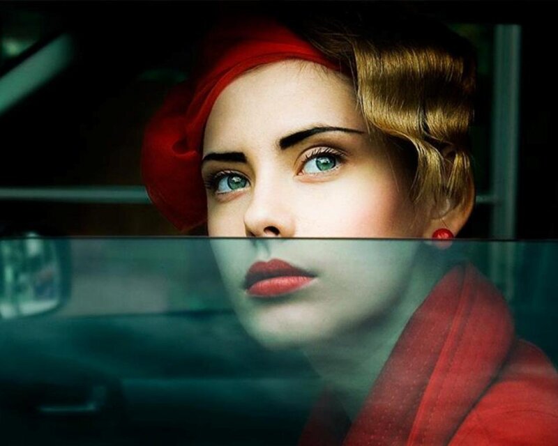 woman in red hat looking out window