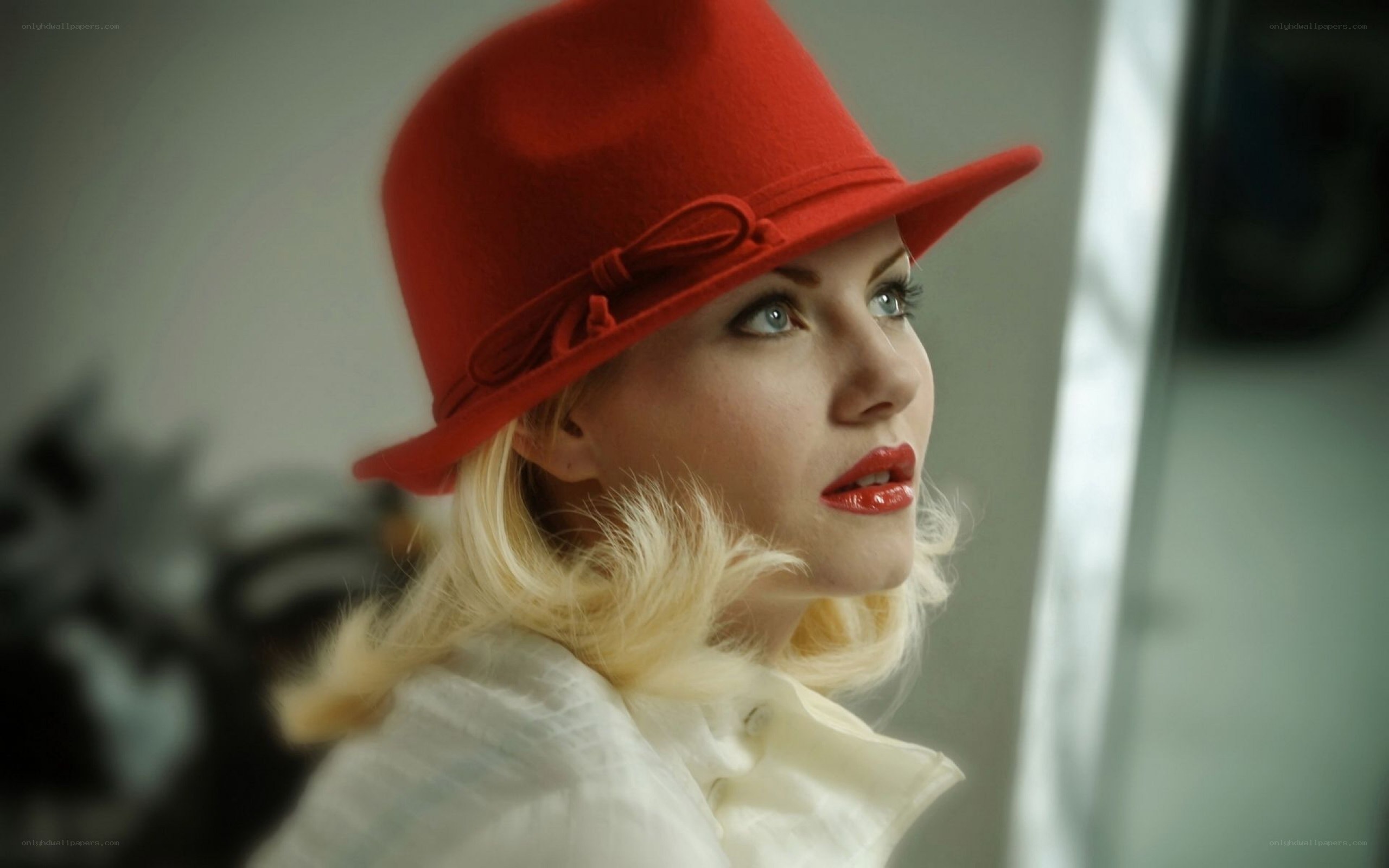 woman in red hat looking out