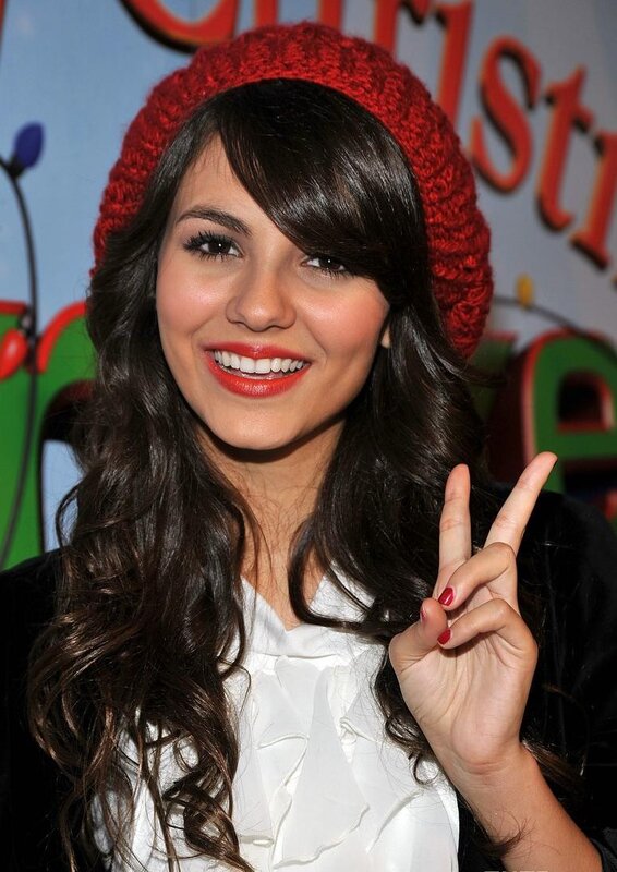 woman in red hat making peace sign