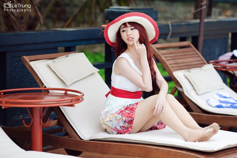 woman in red hat on lounge chair