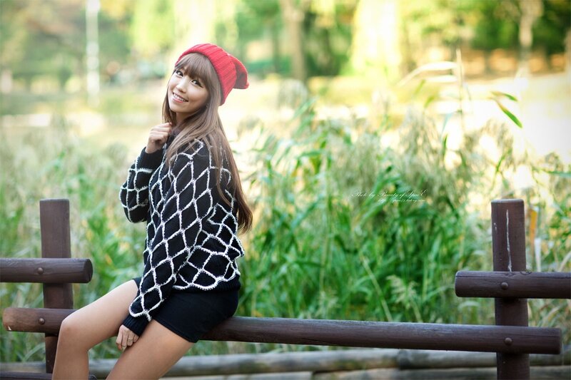 woman in red hat sitting on bench