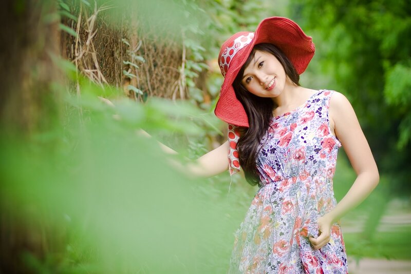 Woman in red hat smiling outdoors