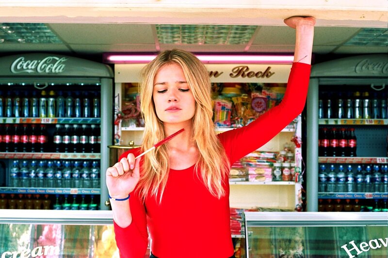 woman in red holding lollipop