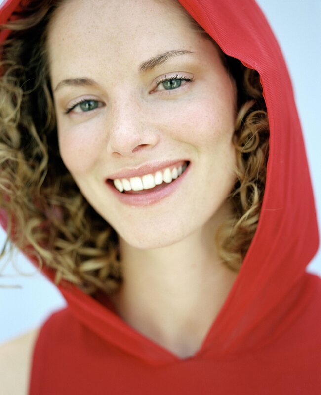 woman in red hood smiling