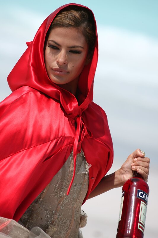 woman in red hood with bottle