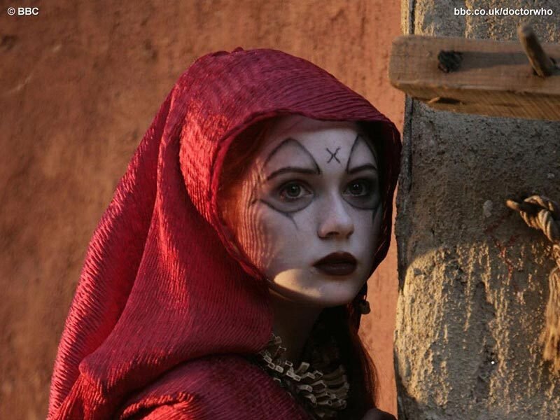 woman in red hood with face paint